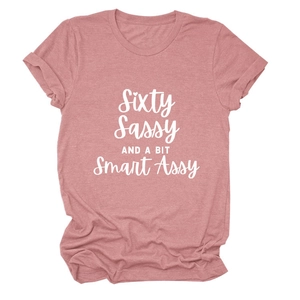 Detail of rose pink t-shirt with white Sixty Sassy AND A BIT Smart Assy printed text