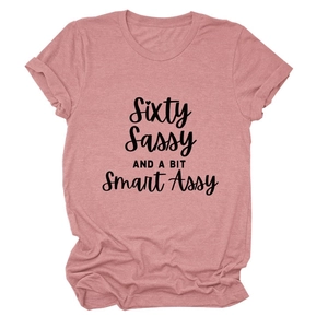 Flat lay of pink cotton T-shirt featuring black Sixty Sassy cursive typography print
