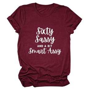 Detail of burgundy crew neck tee with Sixty Sassy slogan and folded sleeve cuffs