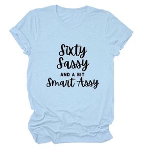 Detail of light blue t-shirt with Sixty Sassy and a Bit Smart Assy black lettering
