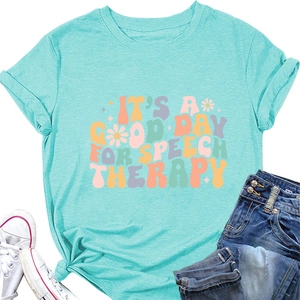 Flat lay of mint green speech therapy slogan tee with white sneakers and blue jeans