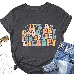 Flat lay of gray speech therapy T-shirt with vintage floral typography and casual accessories