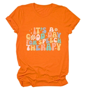 Close-up of orange cotton t-shirt featuring retro 'Speech Therapy' graphic and soft fabric texture