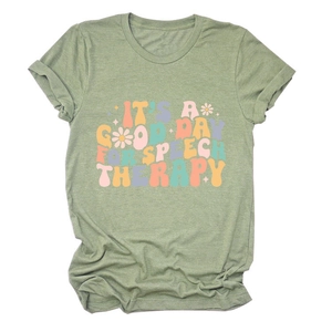 Close-up of speech therapy quote print and daisy flowers on green cotton t-shirt