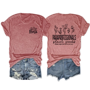 Detail view of brick red t-shirt with floral print and paraprofessional slogan on back