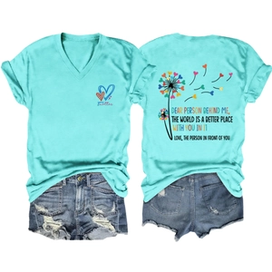 Detail of mint green V-neck T-shirt back showing colorful dandelion heart and quote