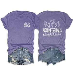 Detail of purple cotton T-shirt featuring flower prints and plant seeds typography design