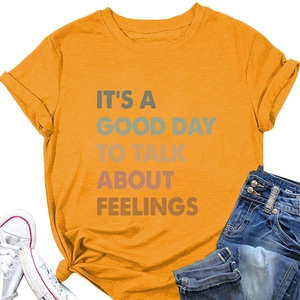 Close-up of ginger yellow t-shirt featuring IT'S A GOOD DAY TO TALK ABOUT FEELINGS slogan