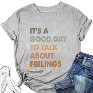 Detail of grey crewneck T-shirt with 'IT'S A GOOD DAY TO TALK ABOUT FEELINGS' text