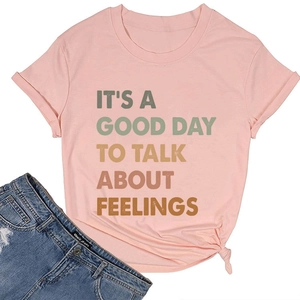Pink crew neck t-shirt with colorful text print and a front knot detail on hem