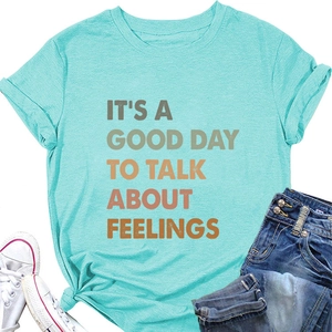 Flat lay of mint green cotton t-shirt with artistic gradient lettering for summer