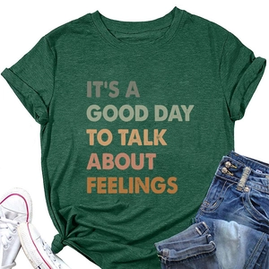 Flat lay of dark green cotton blend t-shirt with slogan print and stylish side knot detail