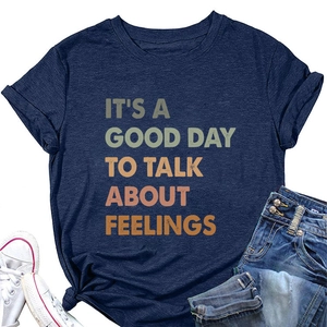 Detail of navy blue cotton t-shirt featuring rainbow text print with cuffed sleeves