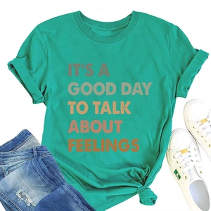 Flat lay of mint green T-shirt featuring It's a good day to talk about feelings slogan