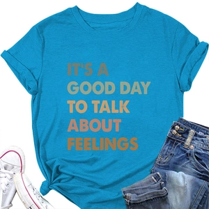 Detail of blue T-shirt with 'IT'S A GOOD DAY TO TALK ABOUT FEELINGS' print and hem knot