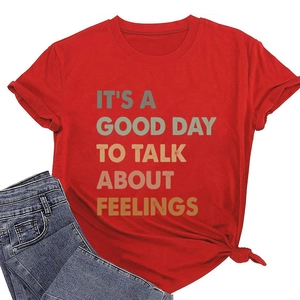 Detail view of red cotton T-shirt with gradient text and stylish side-knot hem design