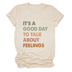 Detail of warm-toned gradient text print on a beige cotton crew neck casual t-shirt