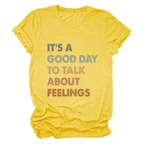 Close-up of bright yellow cotton t-shirt with It's A Good Day To Talk print texture