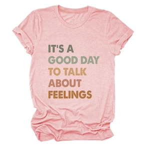 Close-up of pink cotton T-shirt featuring artistic colorful letter print on the front