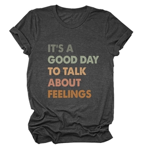 Detailed view of vintage charcoal grey t-shirt with colorful printed slogan texture