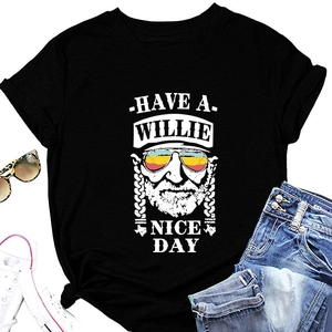 Flat lay of black cotton t-shirt with Willie Nelson print and fashion accessories