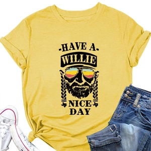 Flat lay of mustard yellow t-shirt with Willie Nelson portrait and slogan detail