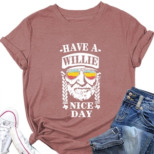 Flat lay of a brick red t-shirt with a Willie Nice Day graphic and casual outfit styling