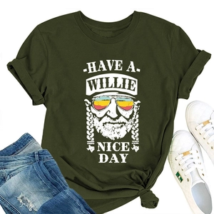 Army green t-shirt flat lay featuring Have a Willie Nice Day print with white sneakers