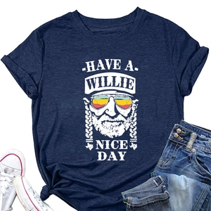Flat lay of navy blue t-shirt featuring vintage Willie graphic with jeans and shoes