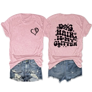 Detailed view of pink T-shirt back with Dog Hair Is My Glitter print and denim shorts