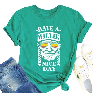 Detail of mint green Willie Nelson graphic T-shirt styled with jeans and sneakers