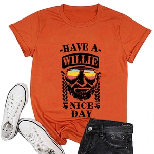 Flat lay of orange cotton T-shirt with Have a Willie Nice Day graphic print and portrait