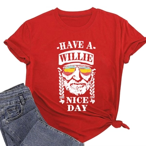 Detail of red crew neck T-shirt with Have a Willie Nice Day graphic and denim jeans