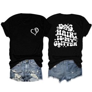 Flat lay of black Dog Hair Is My Glitter t-shirt with ripped denim shorts