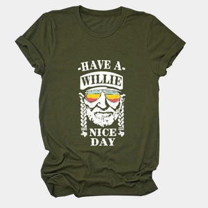 Close-up of olive green T-shirt featuring white Willie Nelson portrait and text print