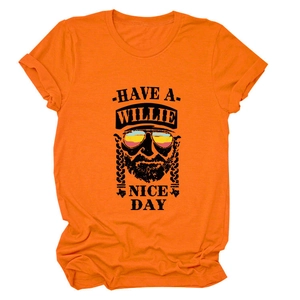 Detail of orange cotton T-shirt featuring retro Willie Nelson graphic and rolled sleeves