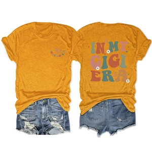 Detail of In My Gigi Era slogan with retro floral print on mustard yellow t-shirt