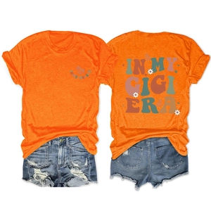 Front and back detail of In My Gigi Era orange t-shirt with daisy floral print and denim shorts