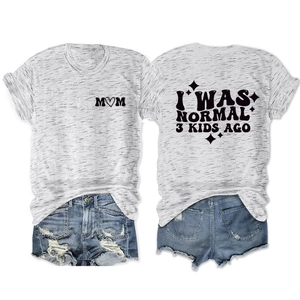 Detail showing 'I WAS NORMAL 3 KIDS AGO' print and distressed denim shorts on gray t-shirt