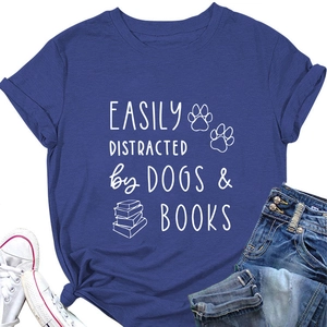 Flat lay of navy cotton T-shirt featuring dogs and books print with jeans and sneakers