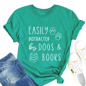 Detail of teal cotton T-shirt featuring dogs and books print with denim jeans