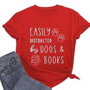 Detail of red cotton T-shirt featuring easily distracted by dogs and books white print