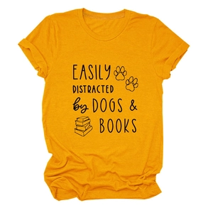 Flat lay of ginger yellow t-shirt showing Easily Distracted by Dogs and Books print