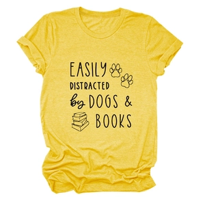 Close-up of yellow cotton t-shirt featuring Dogs and Books graphic print text
