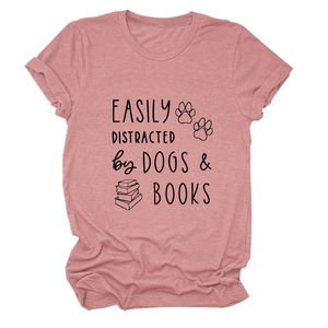 Women's pink t-shirt with 'Easily Distracted by Dogs & Books' print, casual flat lay style