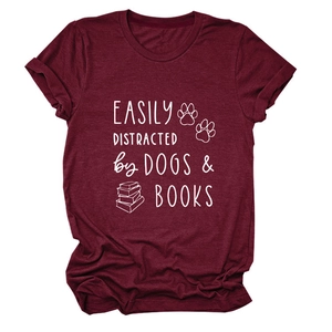 Close-up of burgundy t-shirt with white Easily Distracted by Dogs and Books print