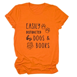 Close-up of printed slogan and dog books graphics on orange cotton t-shirt fabric