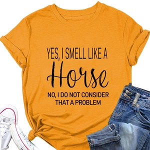 Detailopname van gembergeel katoenen T-shirt met Yes I Smell Like A Horse-tekstprint