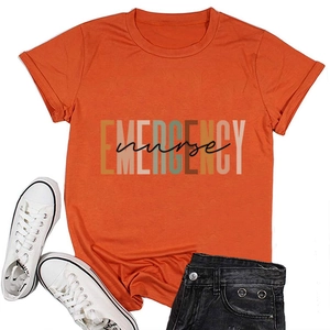 Flat lay of an orange Emergency Nurse cotton T-shirt styled with canvas shoes and denim shorts