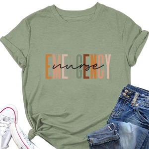 Detail view of sage green Emergency Nurse T-shirt laid flat with denim shorts and shoes